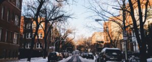 black cars parked in both side of street during winter