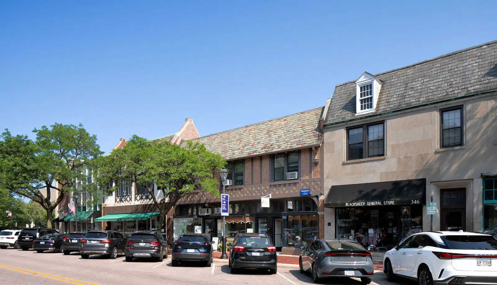 A row of two-story mixed-use buildings at 340–344 Park Avenue in Glencoe, with Tudor-style archit...