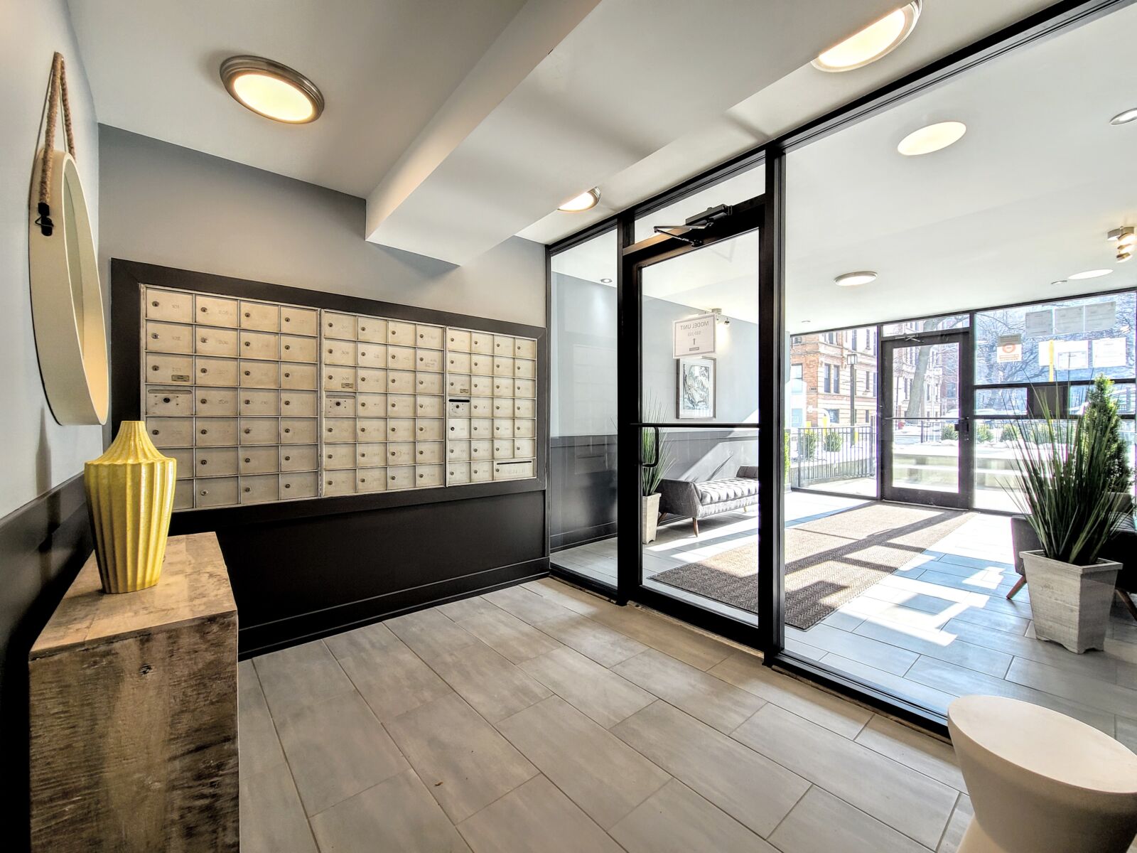 A modern apartment lobby at 530 W. Surf in Chicago's Lakeview neighborhood, featuring floor-...