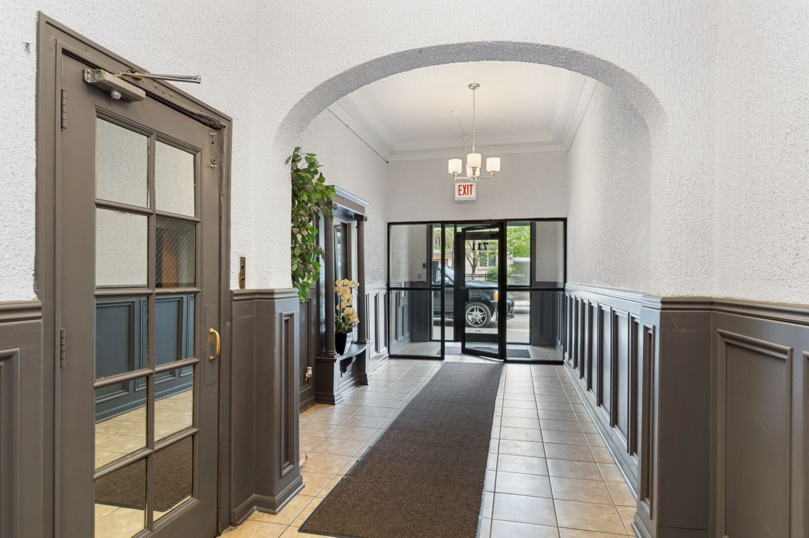 The tiled lobby entrance at 711 West Belmont Avenue in Chicago’s Lakeview neighborhood, featuring...