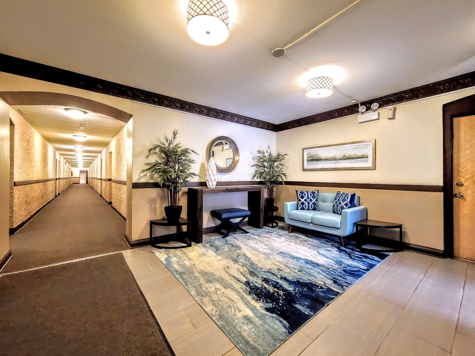 A wider view of the lobby at 536 West Arlington Place, showing the seating area with a loveseat a...