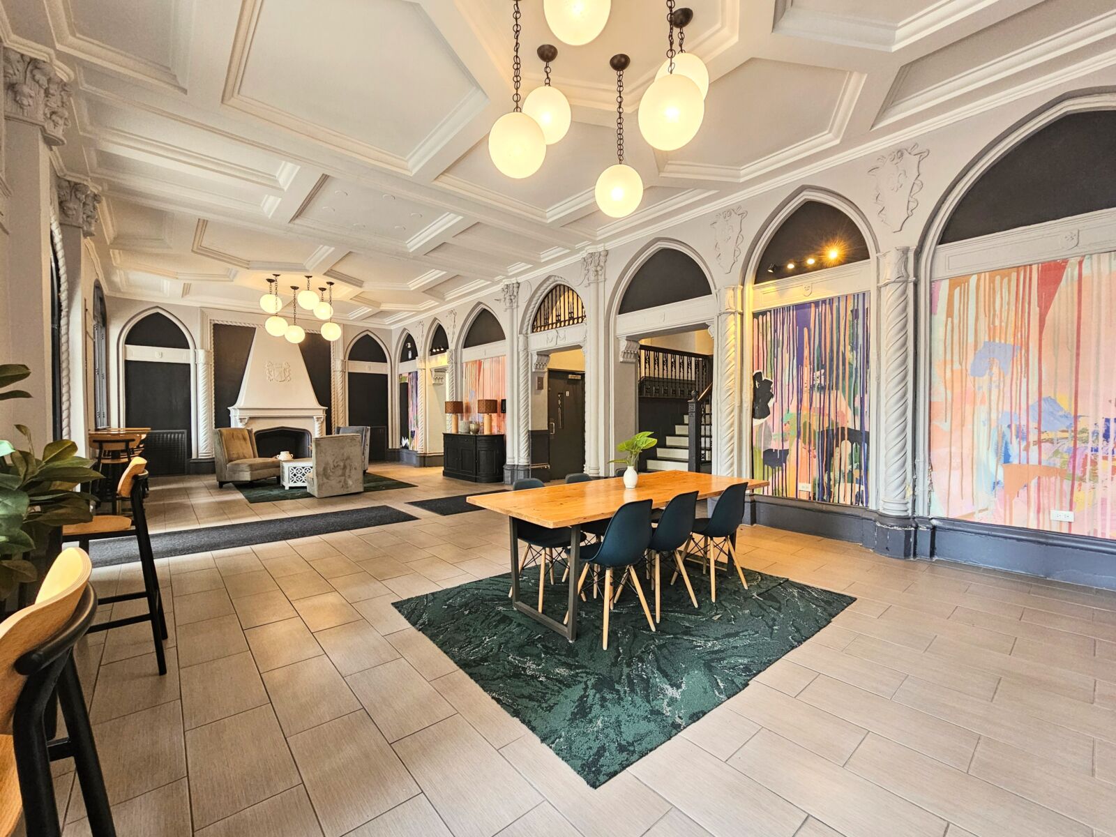 A stylish seating area in the lobby at 505 West Belmont Avenue featuring plush velvet chairs, a c...