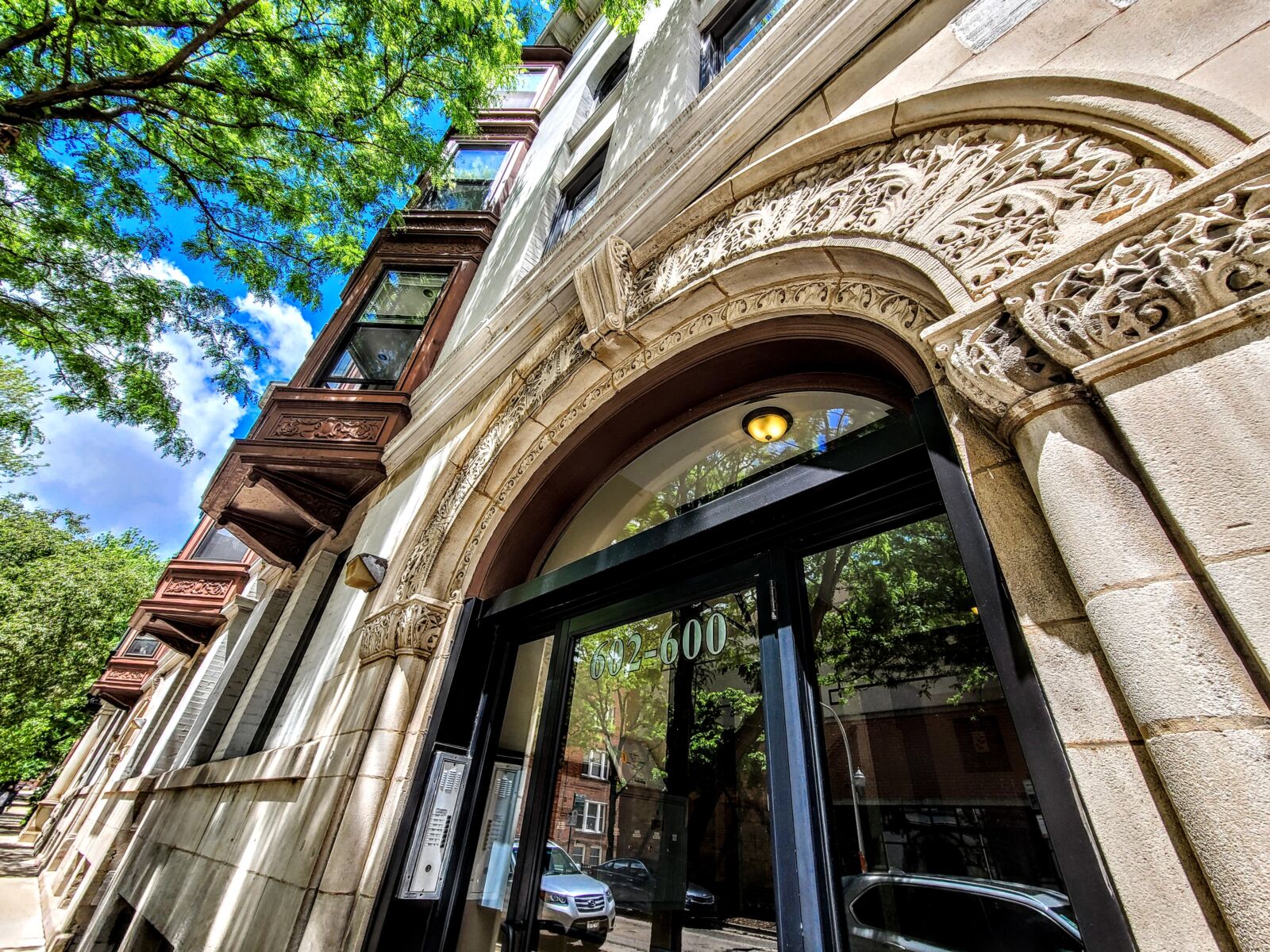 A close-up view of the decorative stone arch above the entrance at 600–606 West Surf Street in Ch...