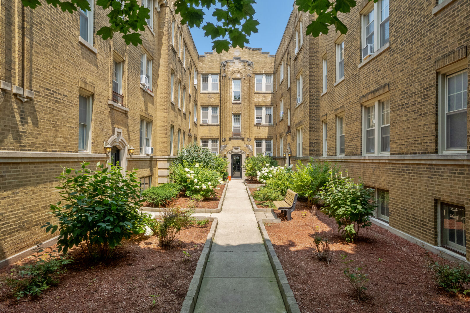 The landscaped courtyard at 2100 West Ainslie Street in Chicago’s Lincoln Square neighborhood, fr...