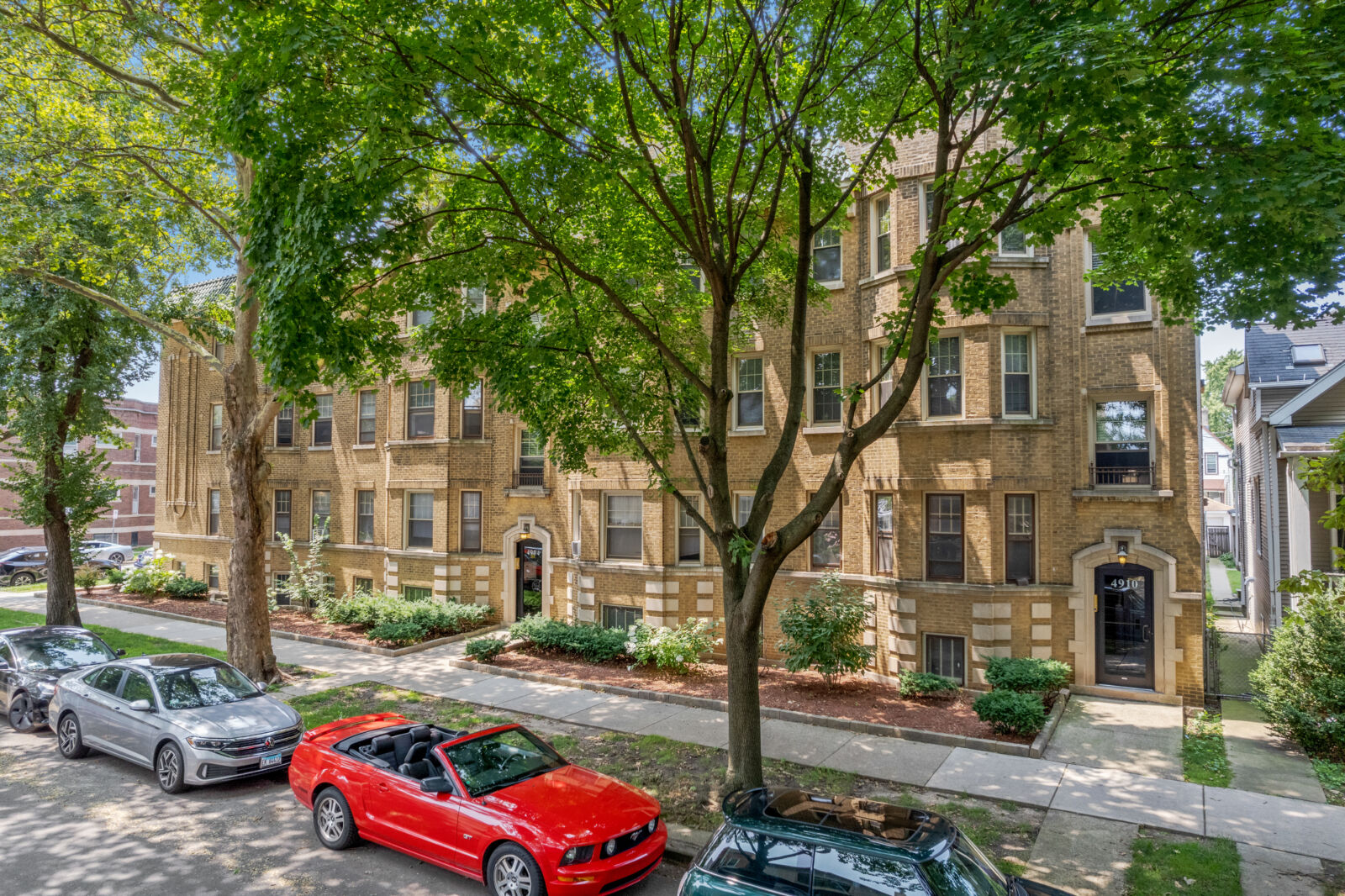 A row of connected four-story yellow brick apartment buildings at 2100 West Ainslie Street in Chi...