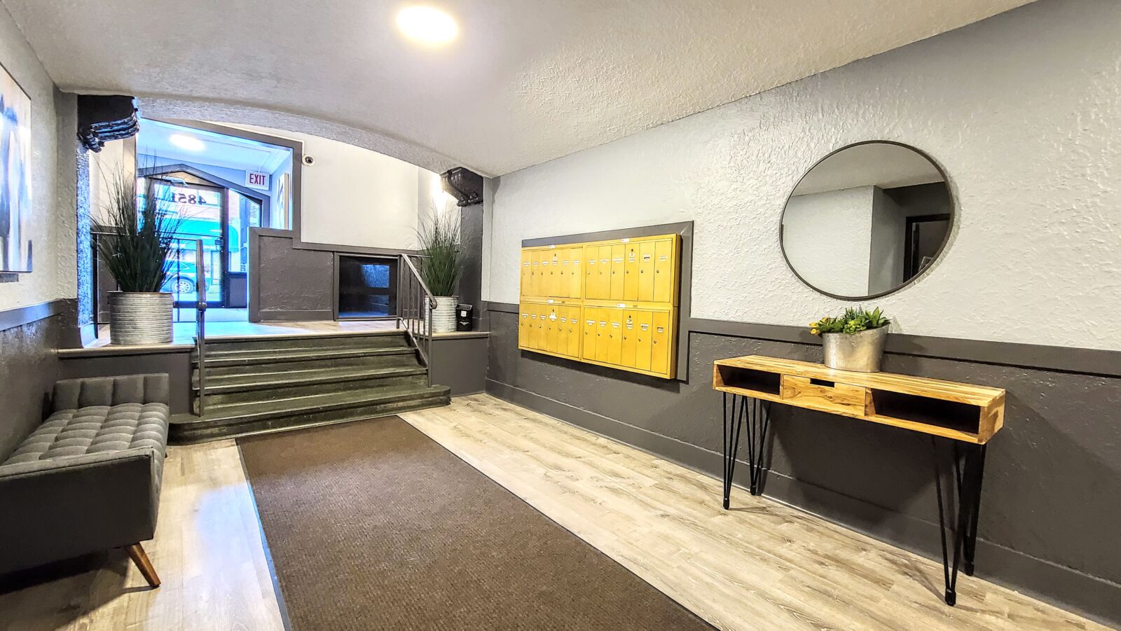 Lobby at 4851 N Damen Ave (Lincoln Square) with steps up to the glass entrance, yellow mailboxes,...