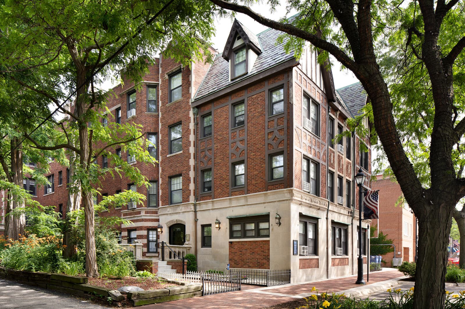 A four-story Tudor-style apartment building at 373 Hazel Avenue in Glencoe, featuring decorative ...